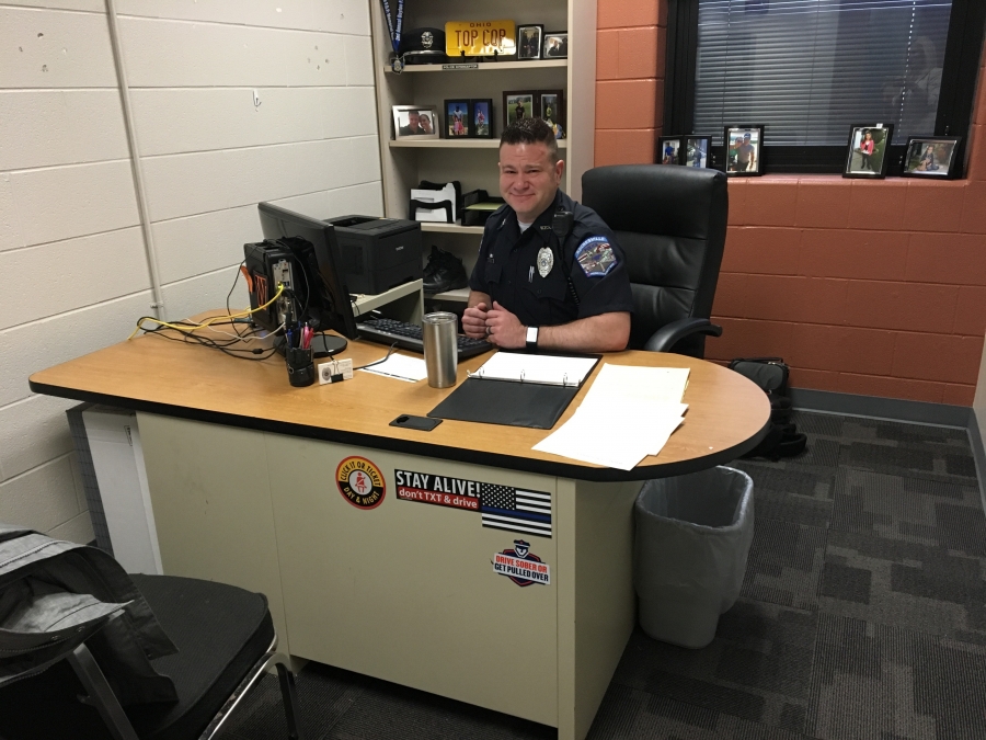 police officer sitting at a desk